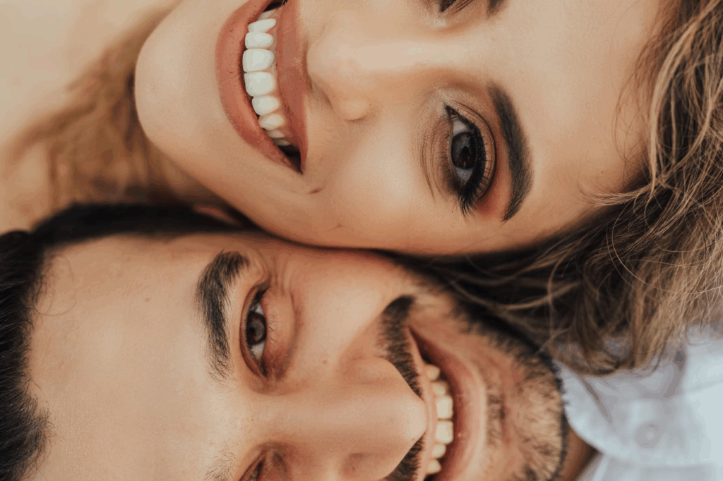half face of a woman and a man smiling brightly