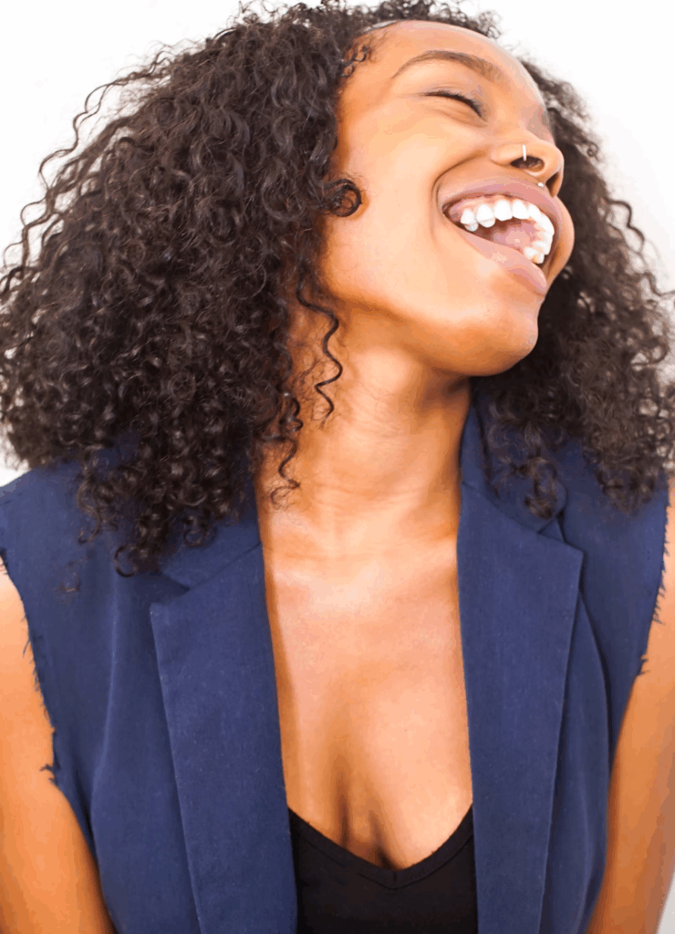 a beautiful woman smiling brightly with mouth wide open