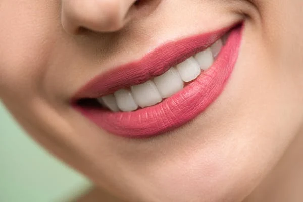 a close up shot of a woman smiling