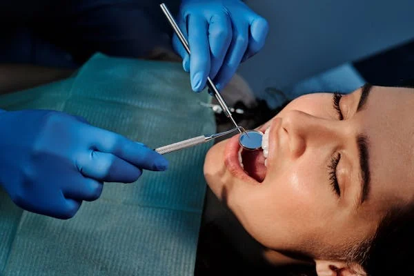 image of a woman with her mouth open during a dental cleaning